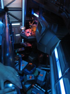 robot at star tours minding piles of fake space luggage